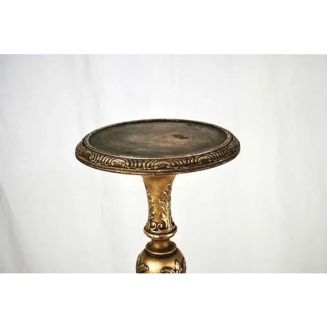 A pair of italian 19th century silver gilt torcheres or candle sticks. Very fine carving of scrolled foliage throughout....