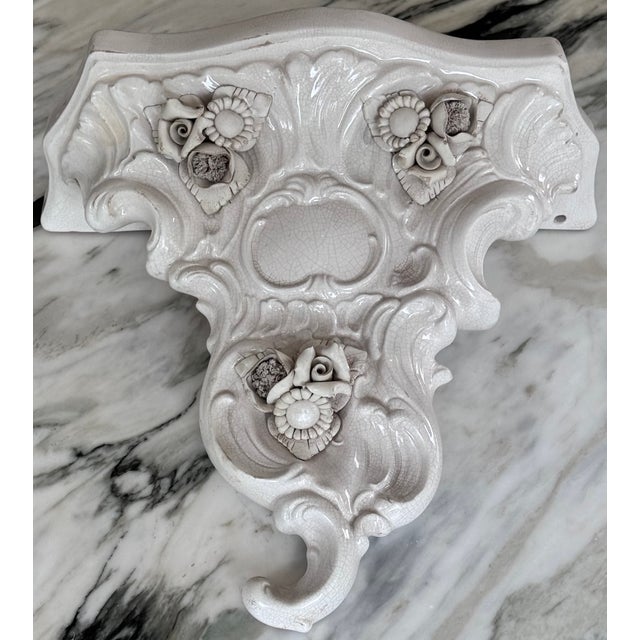 Made in Italy hand painted and glazed terra cotta baroque style wall pocket with delicate floral motif and intentional...