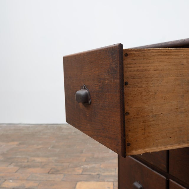 Large oak chest of drawers dating from the early 20th century. It features 18 drawers arranged in three rows, with metal...