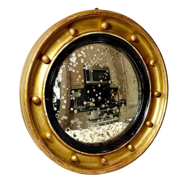 Elegant English Regency convex mirror dating from the early 19th century, circa 1820. The mirror retains its distinctive...