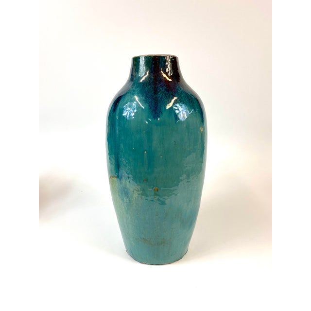 Tall Green-blue vase with an iridescent sheen.