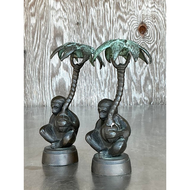 Add an exotic touch to your decor with this charming pair of vintage boho-style patinated monkey candlesticks. Crafted...