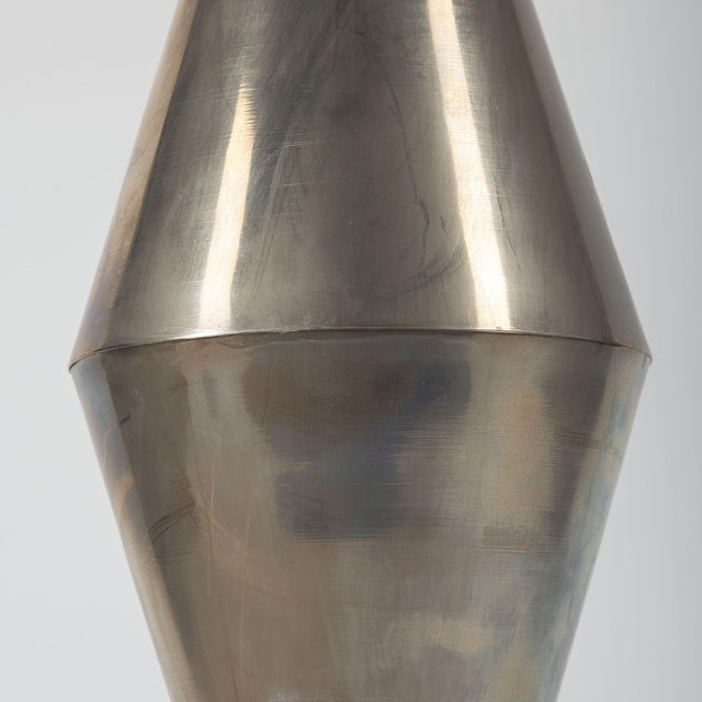 A striking pair of mid-20th century geometric table lamps, executed in polished and brushed silver-toned metal, each...