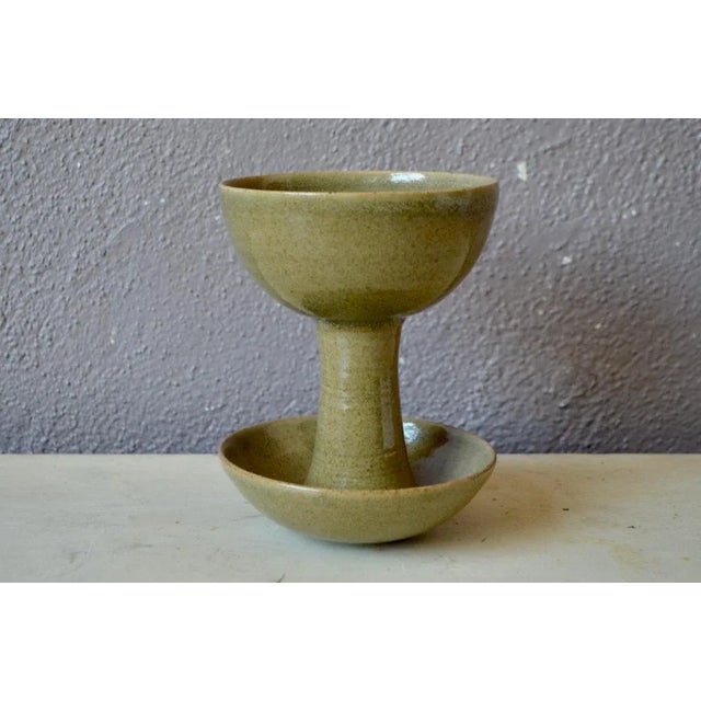 This pretty ceramics duo in sandstone evokes a monastic production. A calyx form is accompanied by a cup, the whole is...