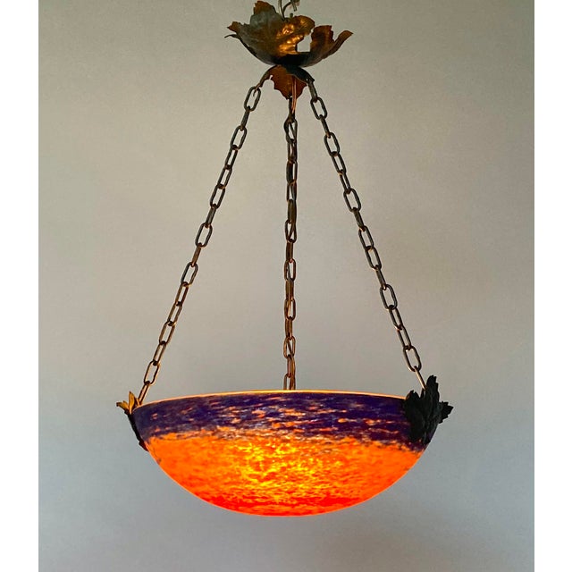 Offering a vibrantly colored antique French lighting bowl in mottled red/oranges and blue/purples, in the manner of...