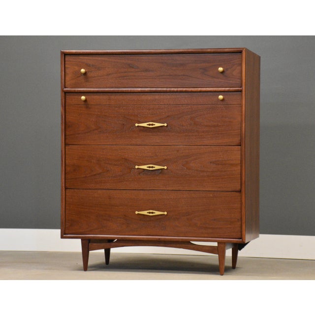 A mid century modern walnut tall dovetail drawer dresser with four drawers made by Kent Coffey The Sceptre. Circa 1960’s....