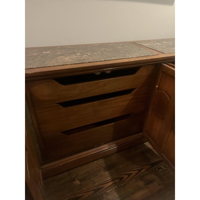 Authentic Henredon credenza featuring a rich walnut finish, ornate circular detailing, and a stunning original marble top....