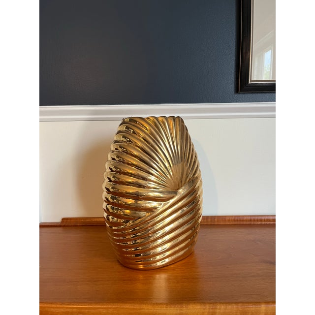 A striking vintage sculptural vase by , executed in a dramatic metallic gold glaze with deeply molded spiral ribbing...