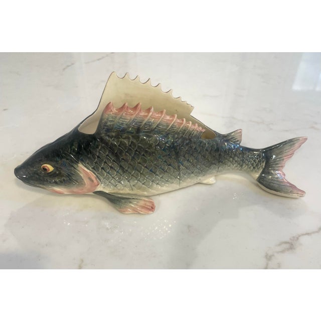 This French Majolica trout vessel has been realistically painted in grey and pink glazing with bright yellow eyes. The...