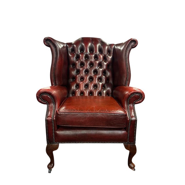 English Chesterfield Wingback Armchair England, mid-20th century Classic English wingback armchair upholstered in deep...