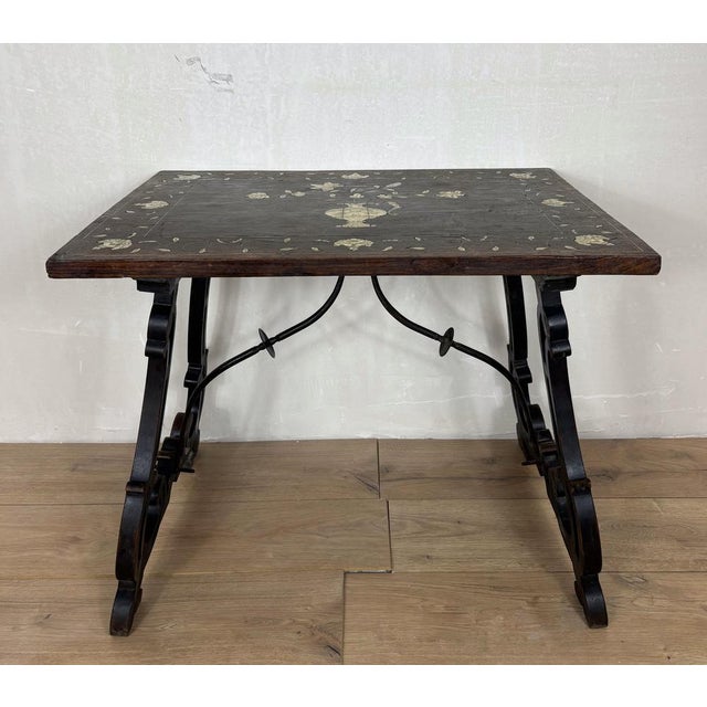 Elegant Spanish Baroque style side table featuring a richly decorated marquetry top with floral inlay centered by an urn...
