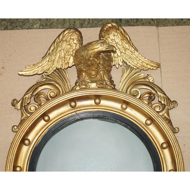 Fully stamped original alban vokins signed regency convex bullseye wall mirror with large hand carved eagle to the top. A...