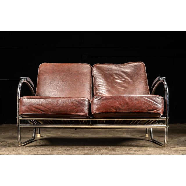 This brilliant example of late 1920s art deco and 1930s streamline design features a set of burgundy colored cushions with...