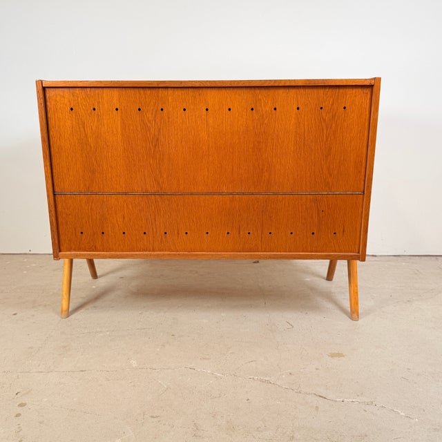 This vintage blanket chest was designed by Frantisek Jirak and produced by Tatra Nabytok in the former Czechoslovakia. The...