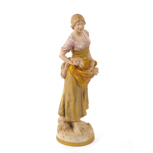 This exquisite early 20th-century porcelain sculpture by Royal Dux showcases the fine craftsmanship and artistic detail...