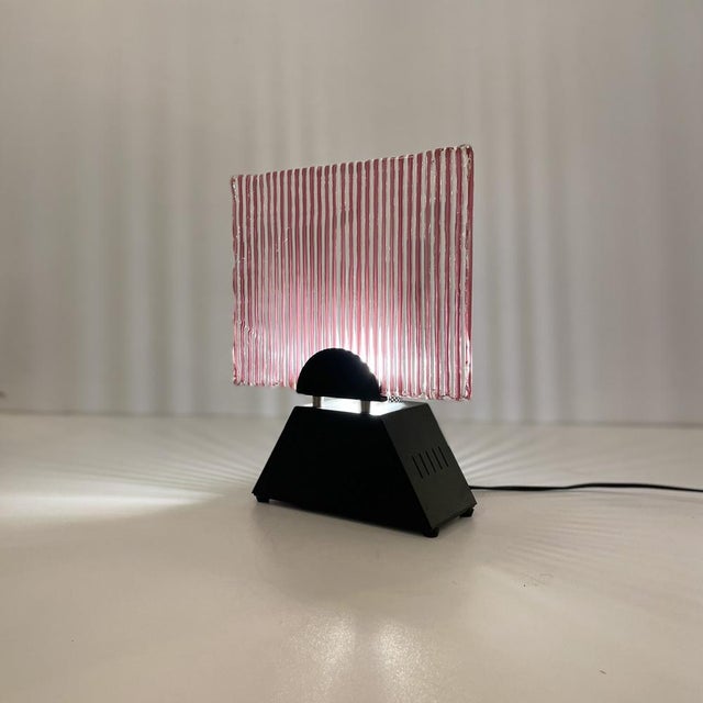 Italian Table Lamp Made in Red Stripes Murano Glass Standing On a Black Metal Base, Awarded to Leucos Murano from 1980’s....