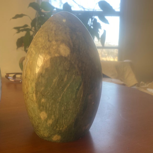These are polished decorative eggs made of natural stone. They feature natural green and white veining.