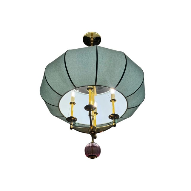 A refined custom-made ceiling light by Collura & Co., distinguished by its sculptural lantern-like silhouette and softly...