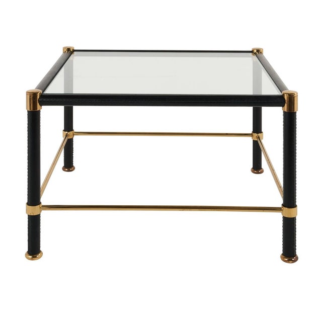 These handsome French glass-top side tables are wrapped in leather with green stitching and brass accents, in the style of...
