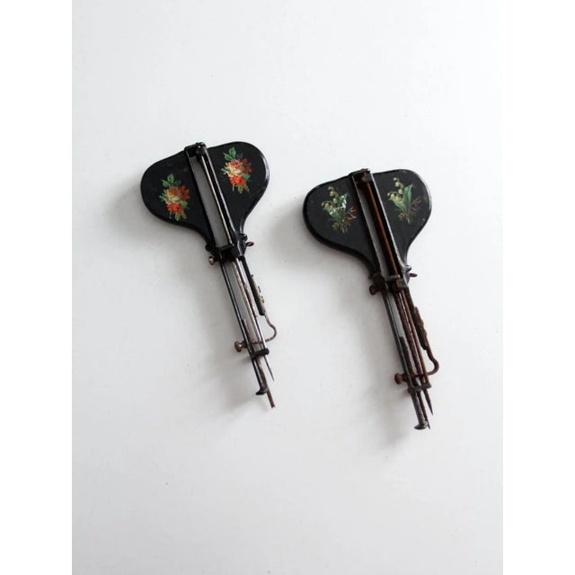 Pair of antique Jewel hand stitchers dating to circa 1886. These Victorian-era sewing tools are crafted from wood,...