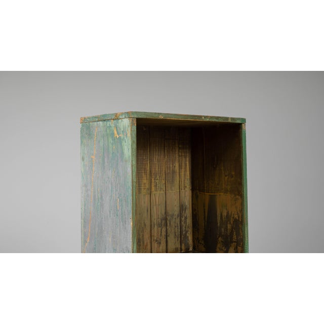 This 20th-century French bookshelf showcases a beautifully weathered patina that reveals layers of green and natural wood...