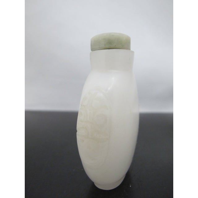 Early 20th Century Chinese Carved Masks White Peking Glass Snuff Bottle With Green Top For Sale - Image 5 of 11