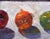 Taking the Spotlight by Clyde Steadman | Oil Painting of three colorful fruits on a surface For Sale