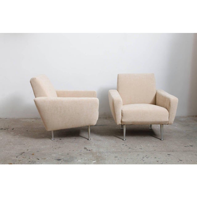 Highly refined vintage lounge chairs, a sculptural set of 2 chairs, reupholstered in ecru velvet, standing on chromed legs...
