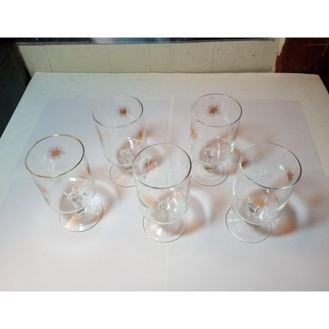 Five atomic Starburst Cordial Glasses made in the 1960s. They stand around 6" tall & hold approximately 10 ounces. There...
