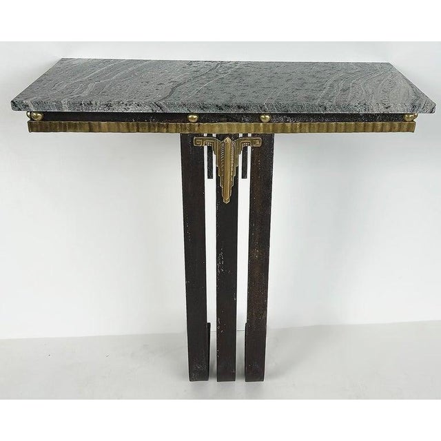 Offered for sale is a finely crafted Art Deco wall-mounted console table in brass, wrought iron, and marble. The console...
