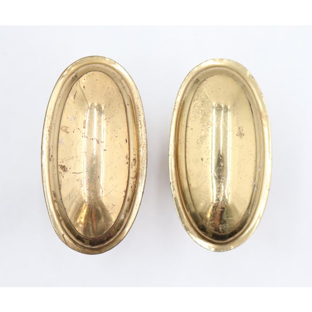 Reclaimed oval shaped entry door knobs made of brass with a polished finish. Good condition with surface wear from prior...
