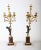 A fine pair of French 18th century bronze and gilt bronze candelabra, each in the form of putto figures holding aloft...