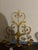 An exceptional pair of monumental gilt iron wall candelabras with elegant scrolling ironwork, stylized tulip details, and...