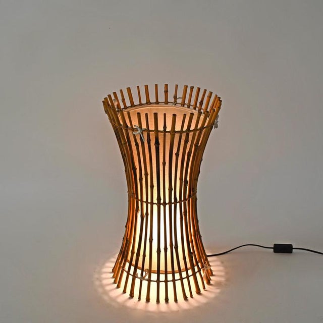 Wonderful and elegant mid-century floor or large table lamp entirely handcrafted in bamboo and hand-woven rattan wicker,...