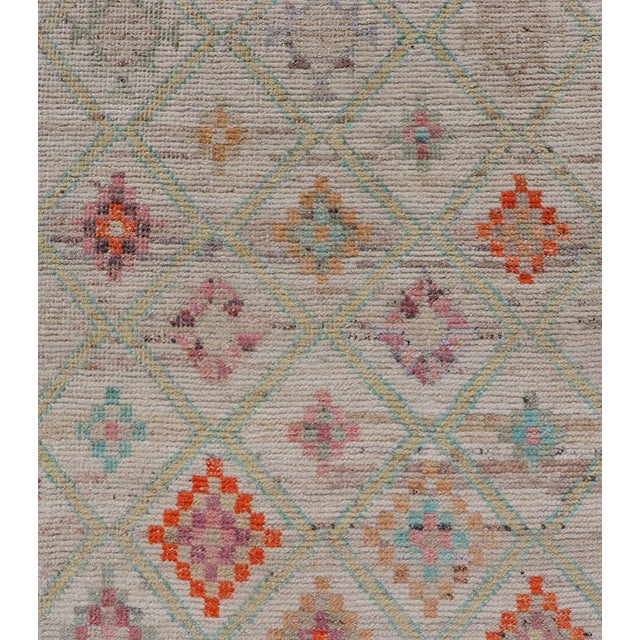 Measures: 2'8 x 9'8. This modern casual tribal Tulu runner has been hand-knotted in wool. The rug features a modern sub-...