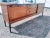 This is a 89" vintage mid century ribbon mahogany sideboard by Bramin Mobler. The sideboard has sliding doors that have...