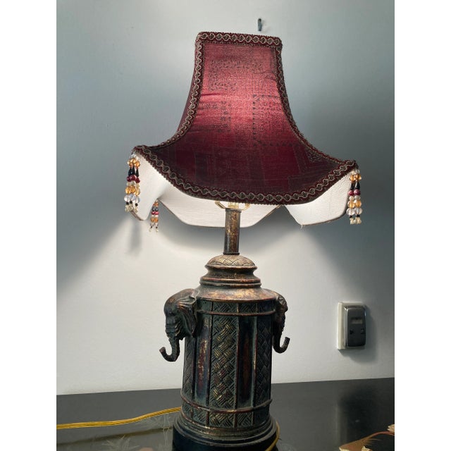 This rare lamp has a mix of Africa and Asia. Excellent used condition. The lamp has two elephant heads, one on the right...