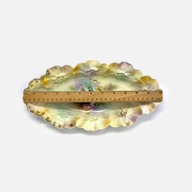Lovely antique RS Prussia celery or relish dish featuring a beautiful arrangement of flowers. Features an ornate,...