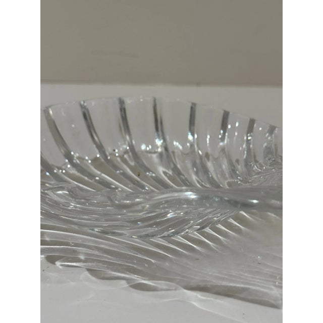 Elegant Baccarat crystal dish in the shape of a scallop shell. Features brilliant ribbed detailing that beautifully...