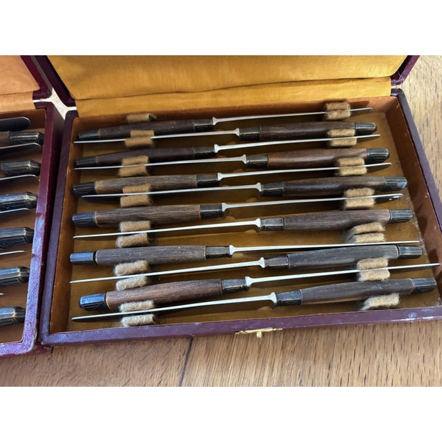 A dinner service that tells a story. twenty-four french knives from the 1930s, presented in their two original cases made...