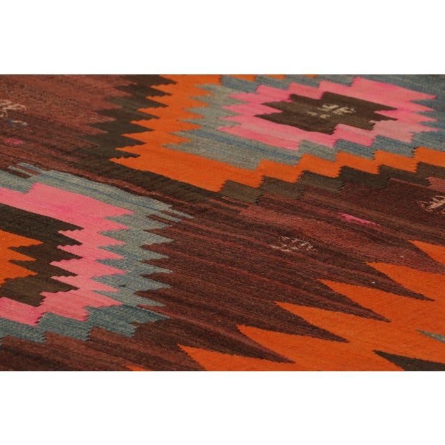 Handwoven in wool, circa 1950-1960, this 5x9 vintage Turkish kilim, is a collectible piece featuring polychromatic...