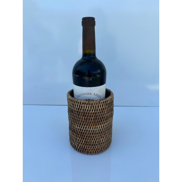 Hand woven, cylindrical rattan bottle holder by Matahari. Made in Myanmar.
