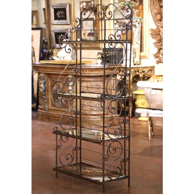 Elegant and airy in profile, this antique French étagère combines graceful scrollwork with the practical versatility of...