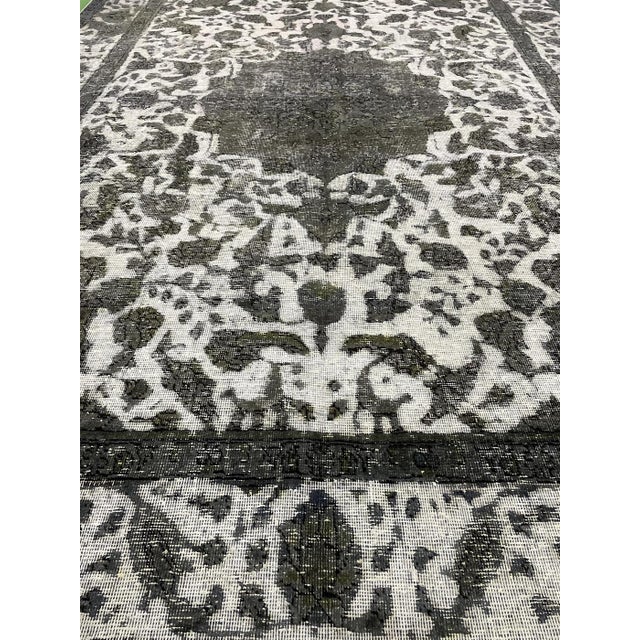 This distressed vintage Persian Tabriz rug is hand-knotted in Iran around 1940's.This vintage Persian Tabriz rug is...