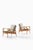 This rare pair of easy chairs, attributed to ib kofod-larsen and produced by trensums möbelfabrik in sweden, reflects the...