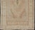 Vintage oushak Turkish rug from Anatolian region of Turkey displays muted colors and delicate tones with florals and...