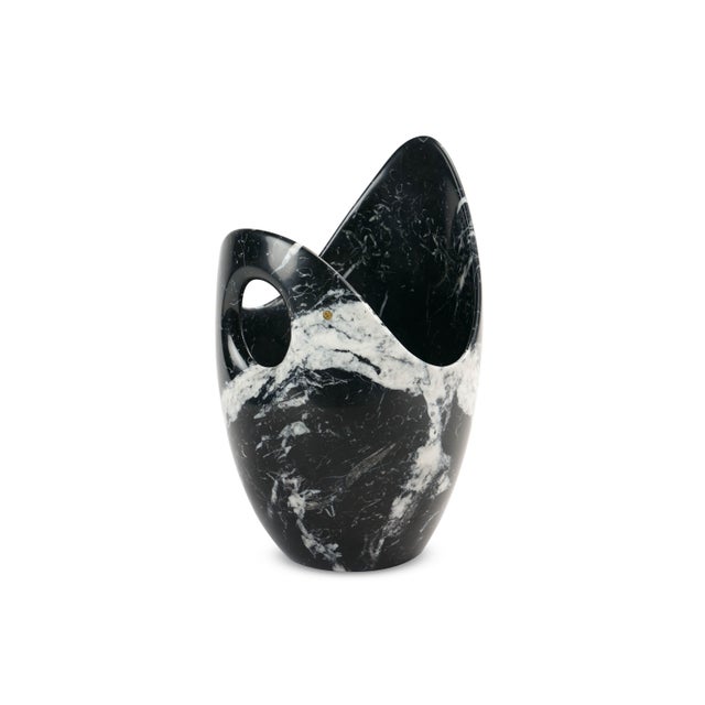The champagne cooler by Barberini & Gunnell, sculpted from luxurious Marquina marble, is a bold and refined statement of...