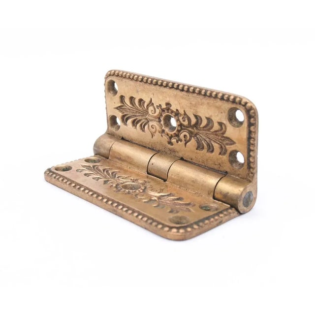 Antique bronze butt door hinge with flat tips, five knuckles and an unusual leafy design and curved corners. One...