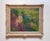The painting depicts a young girl seated amidst a vibrant garden, surrounded by an array of colorful blooms that create a...