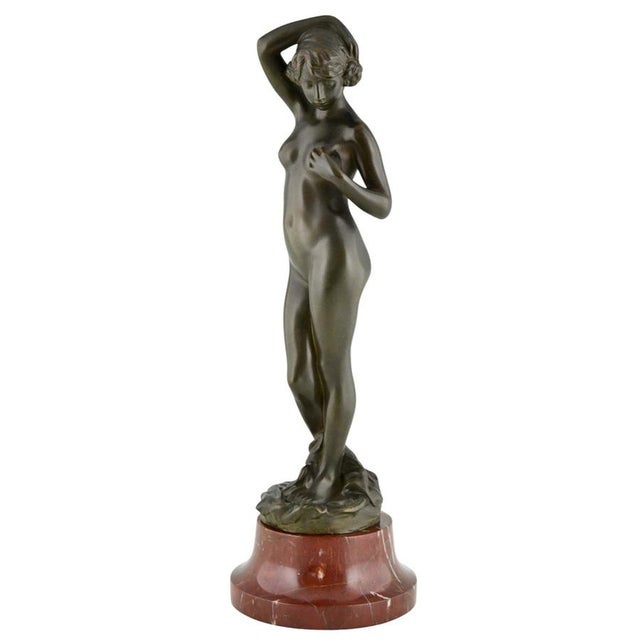 Art Deco Bronze Female Nude Sculpture – Alexandre Caron, 1920 An elegant and refined Art Deco bronze sculpture depicting a...
